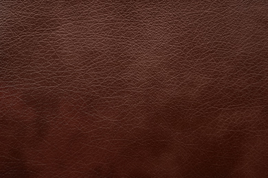 Texture of dark brown leather as background, closeup