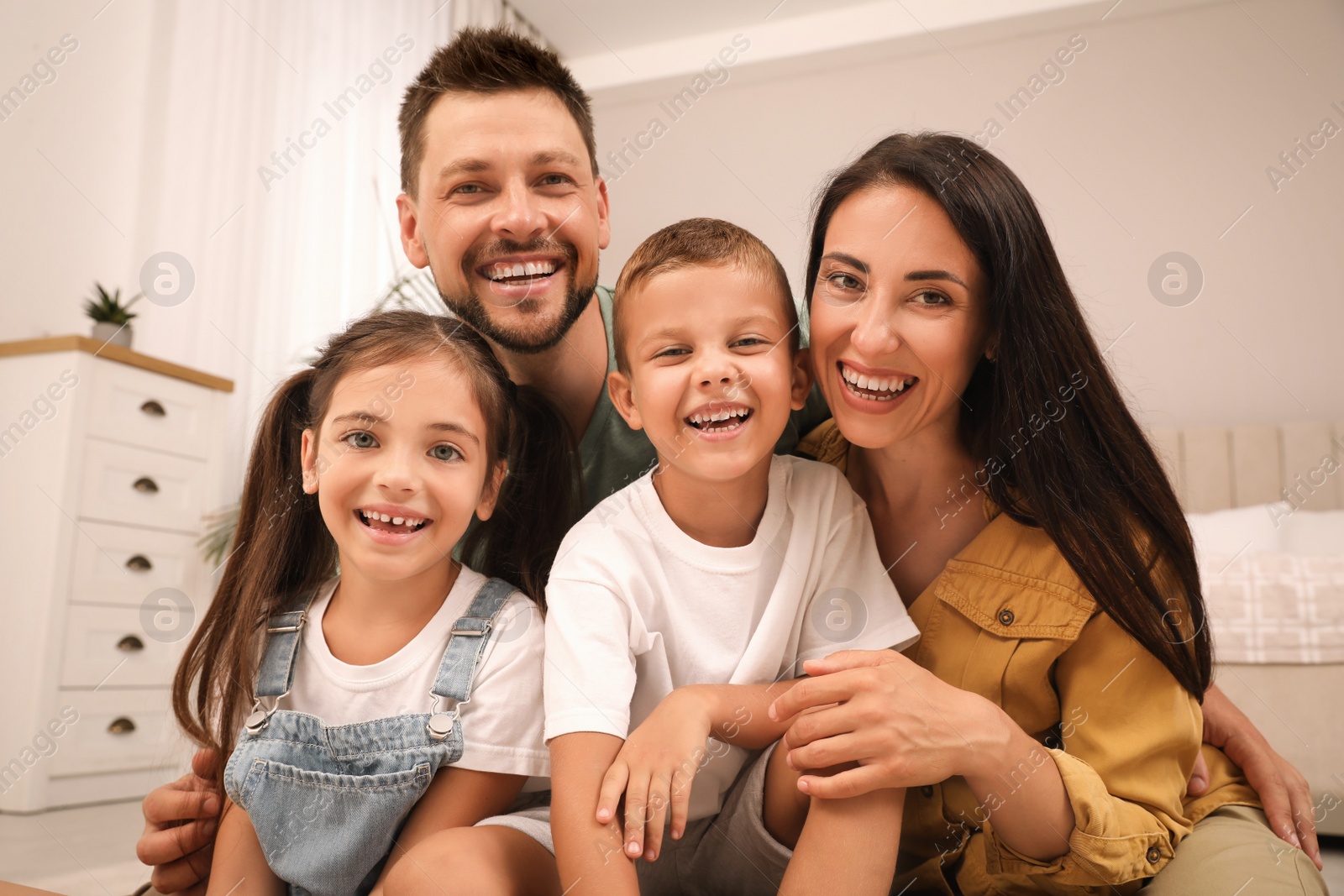 Photo of Portrait of happy family with children at home