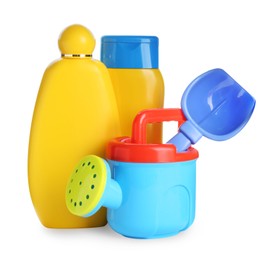 Photo of Different suntan products and plastic beach toys on white background