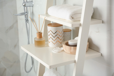 Photo of Shelving unit with different items in bathroom interior