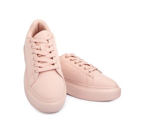 Pair of comfortable pink shoes on white background