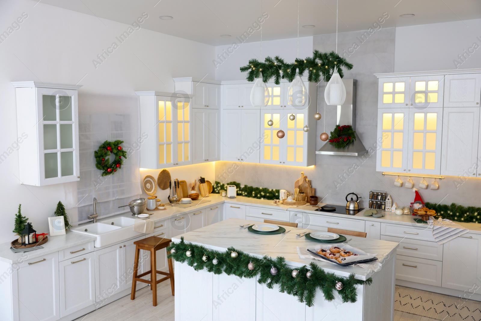 Photo of Cozy spacious kitchen decorated for Christmas. Interior design