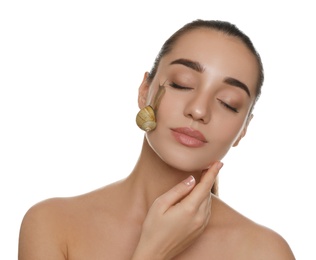 Photo of Beautiful young woman with snail on her face against white background