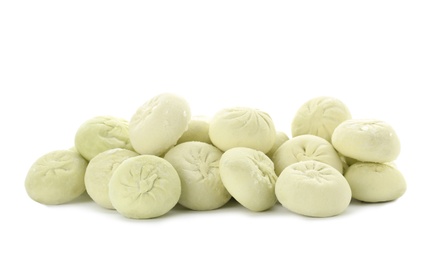 Heap of raw dumplings with tasty filling on white background