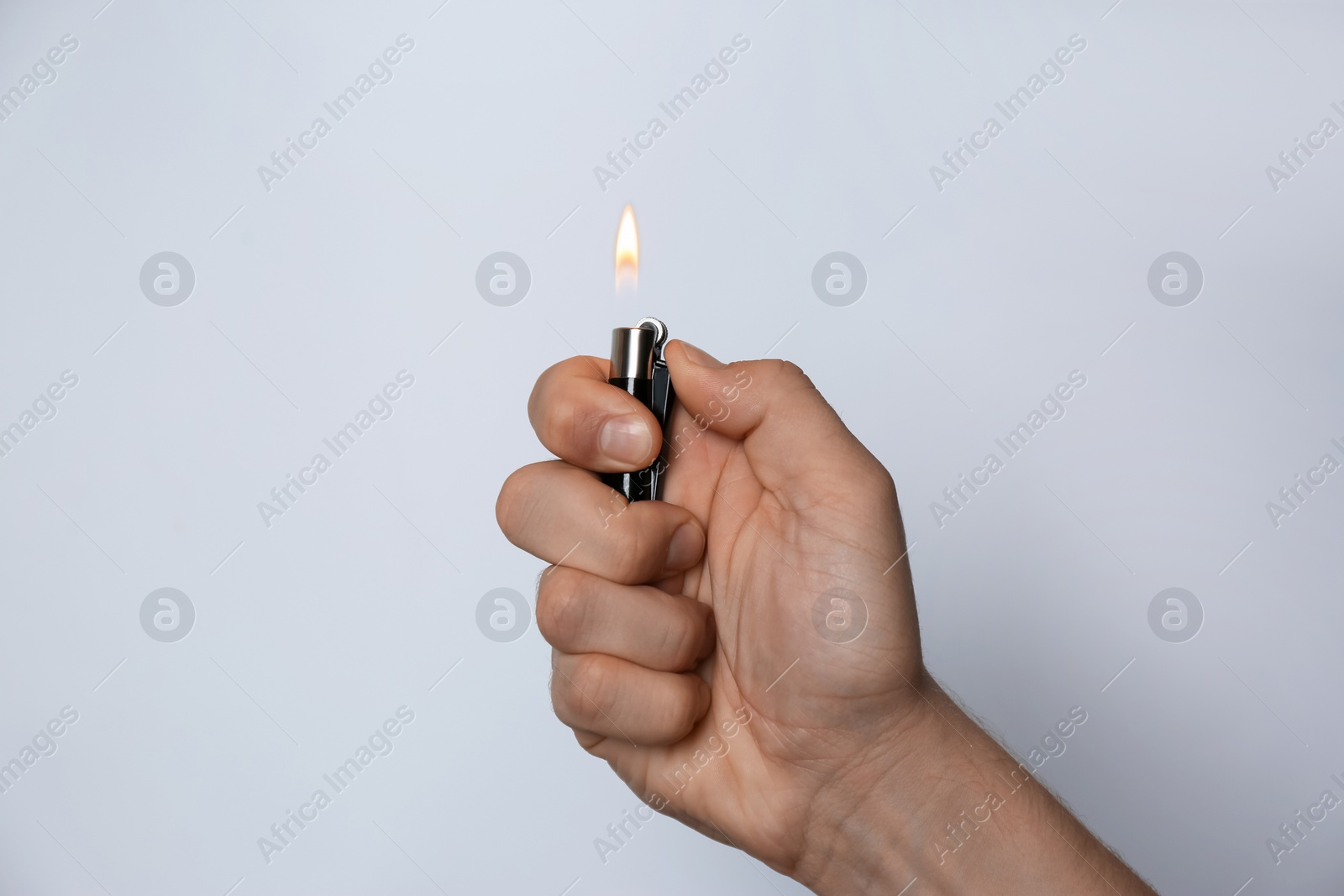 Photo of Man holding lighter on white background, closeup