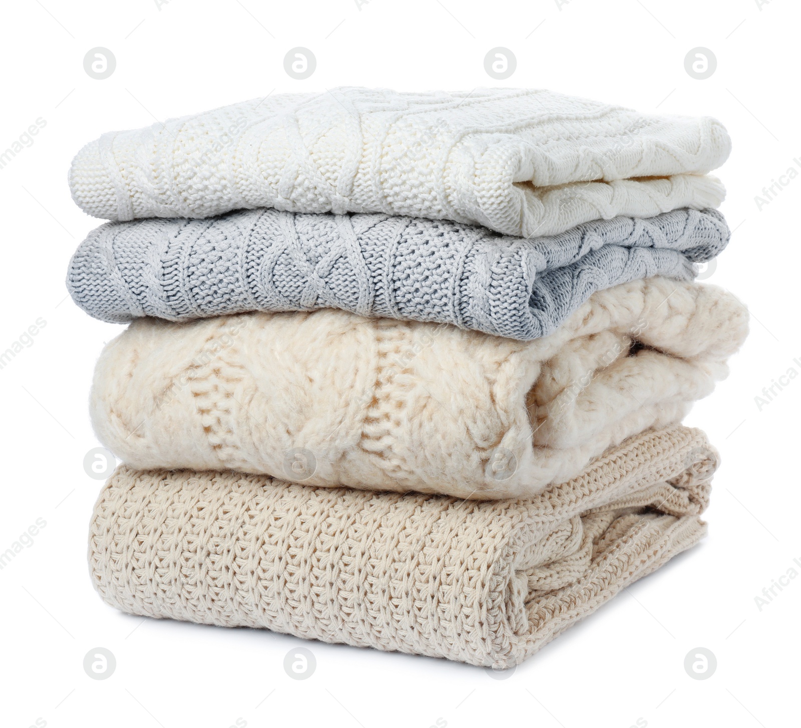 Photo of Stack of folded knitted sweaters on white background