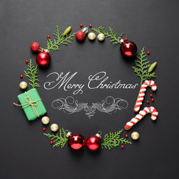 Image of Flat lay composition with text MERRY CHRISTMAS and festive decor on black background