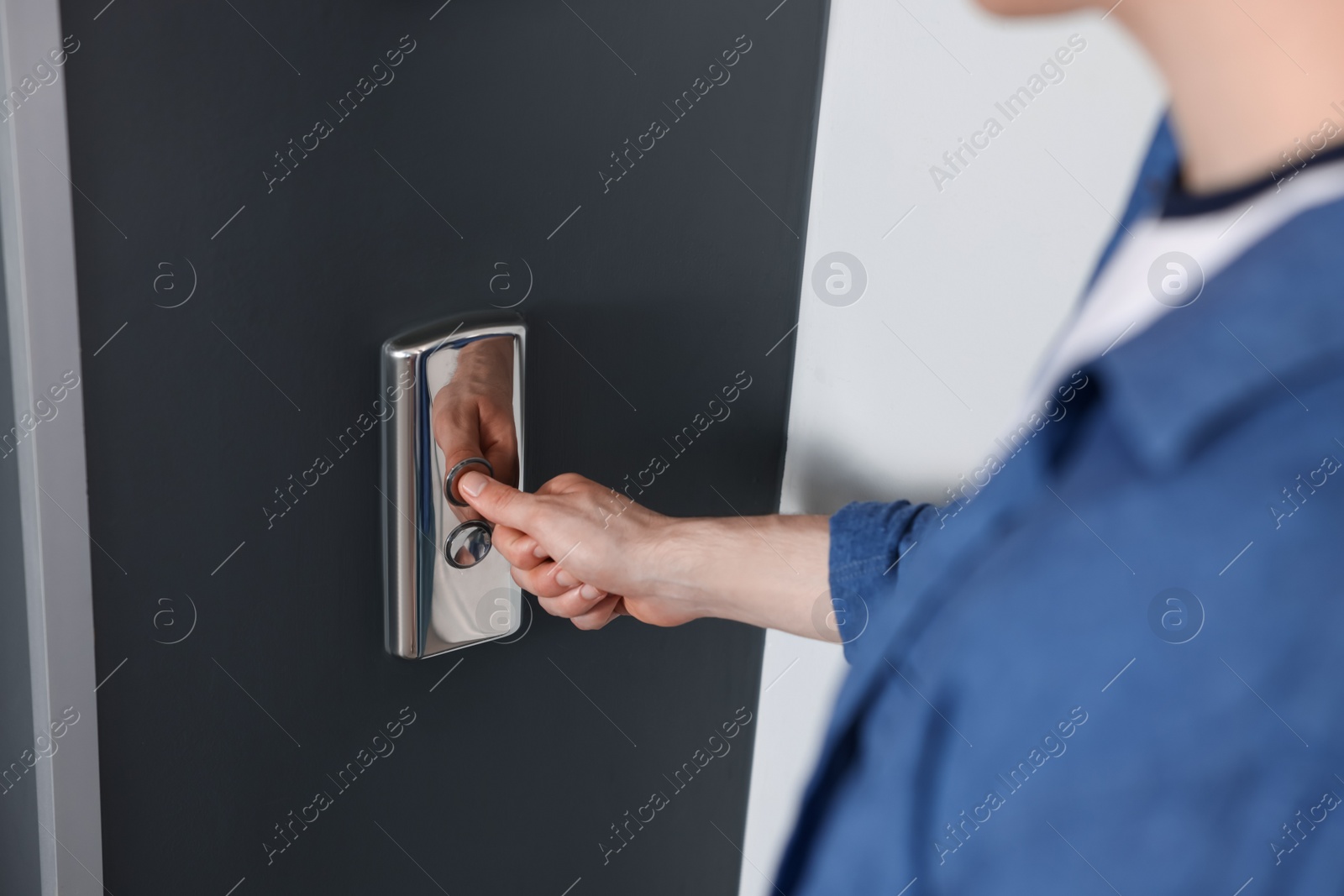 Photo of Man pressing elevator call button, closeup view