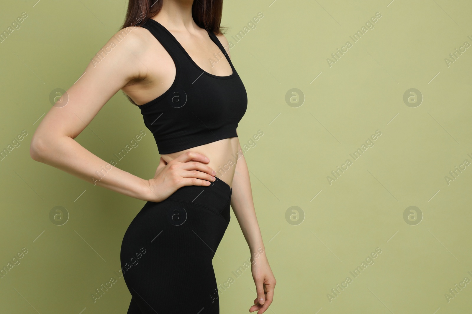 Photo of Woman with slim body on green background, closeup. Space for text