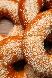 Photo of Delicious fresh bagels with sesame seeds on table, top view