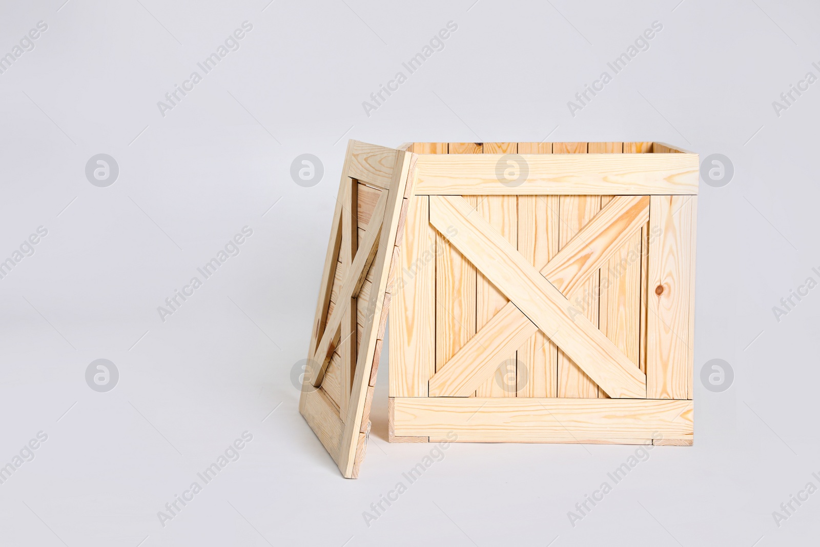 Photo of Open wooden crate on grey background. Space for text