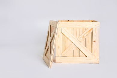 Photo of Open wooden crate on grey background. Space for text