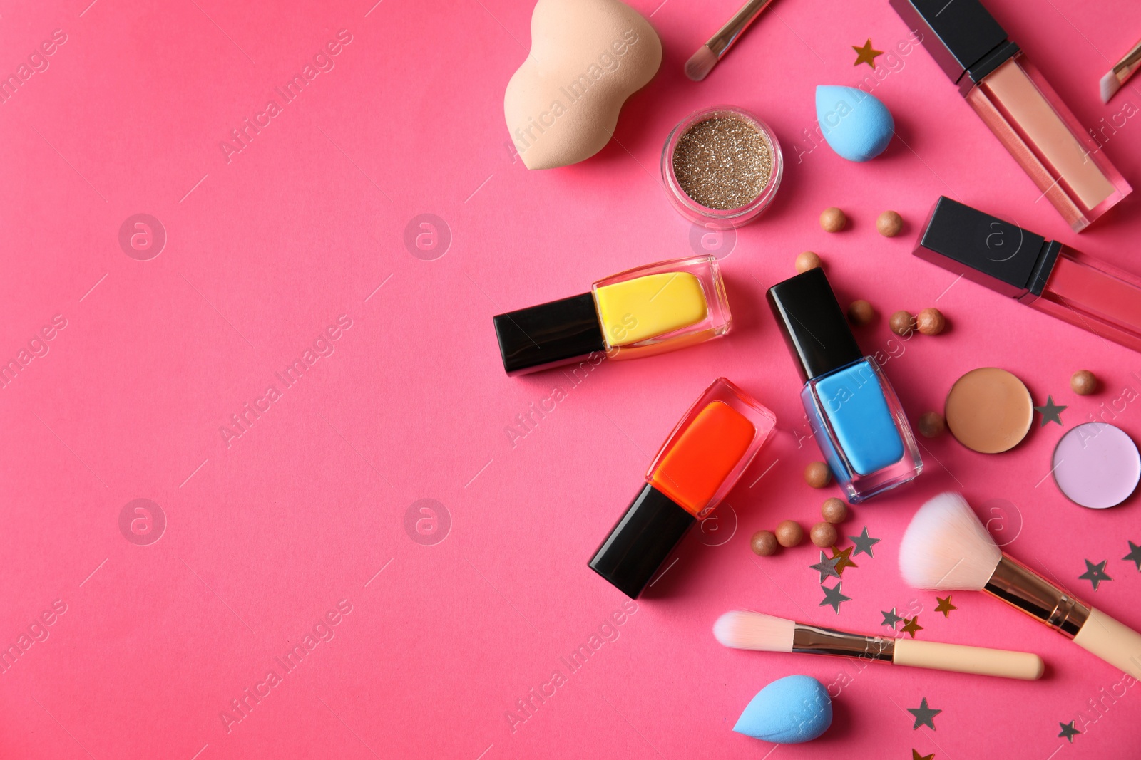 Photo of Flat lay composition with cosmetics, bottles of  nail polish and space for text on color background