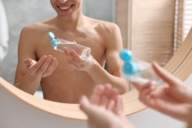 Photo of Man with lotion in bathroom, closeup view