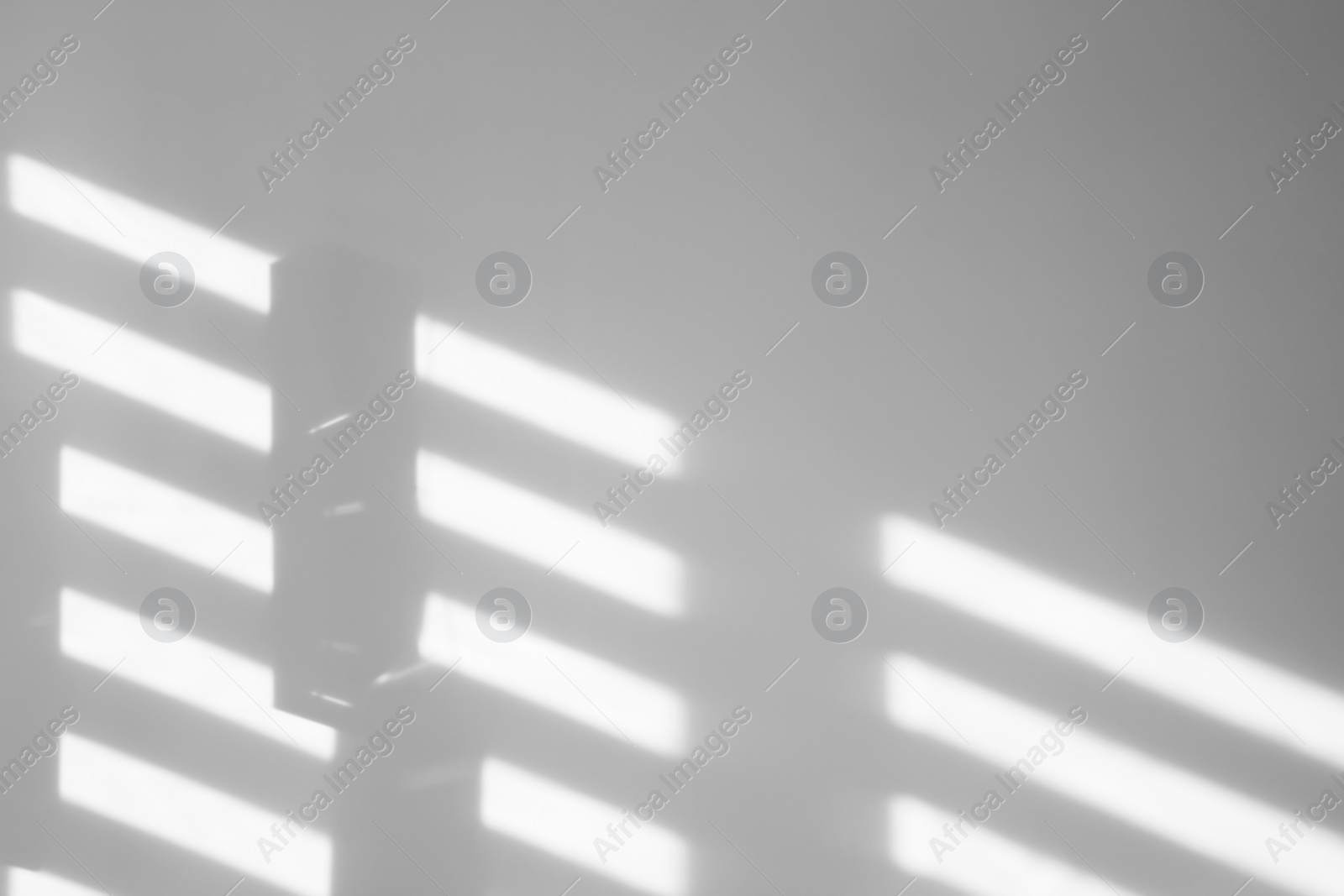 Image of Light and shadows falling on white wall