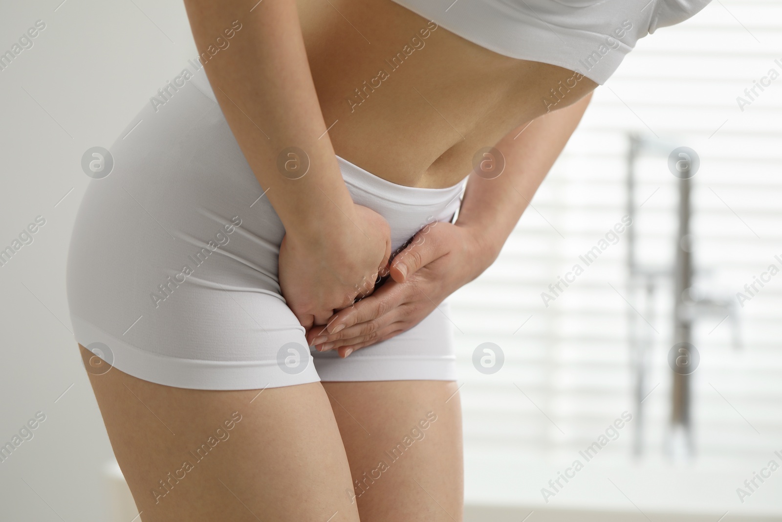 Photo of Woman suffering from cystitis at home, closeup. Space for text
