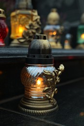 Photo of Grave lights on granite surface at cemetery