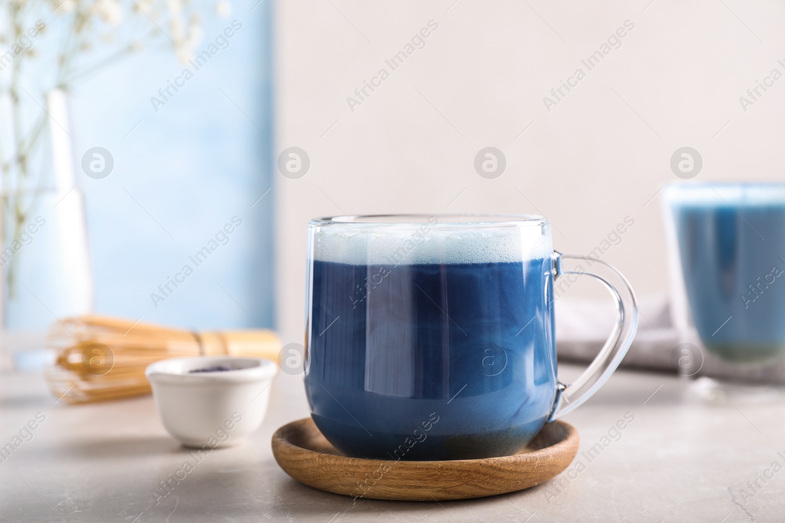 Photo of Delicious blue matcha drink on light grey table