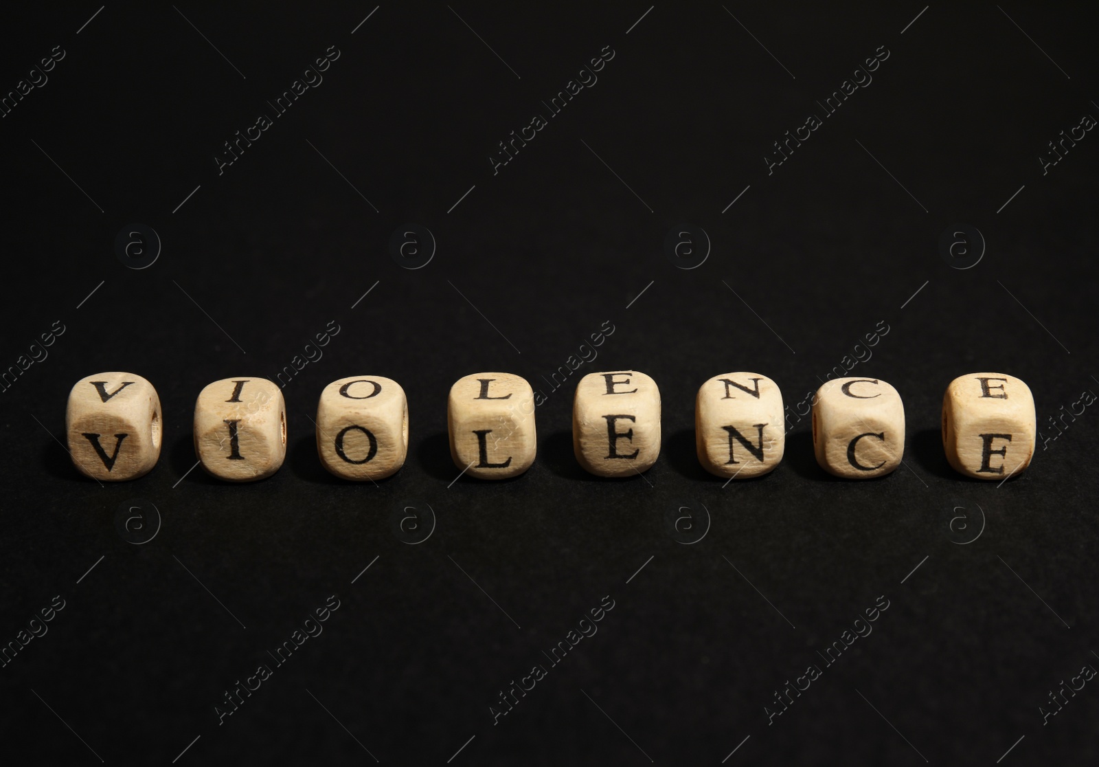 Photo of Word VIOLENCE made of wooden cubes on black background