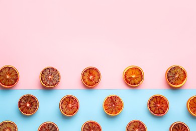 Many ripe sicilian oranges on color background, flat lay. Space for text
