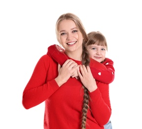 Happy woman and daughter in stylish clothes on white background