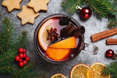 Photo of Flat lay composition with aromatic mulled wine on grey table, closeup