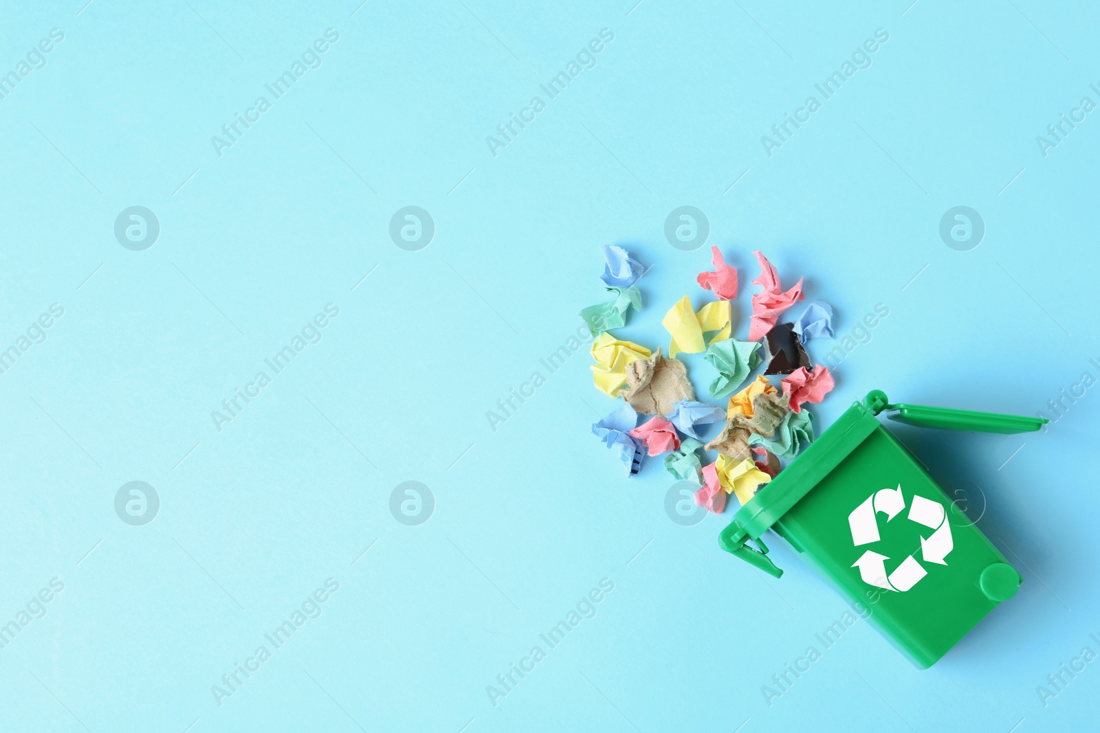 Photo of Trash bin and different garbage on color background, top view with space for text. Waste recycling concept