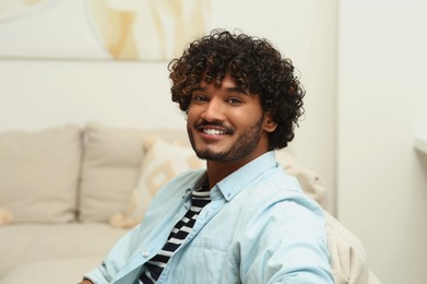 Portrait of handsome smiling man in room