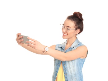 Young beautiful woman taking selfie against white background