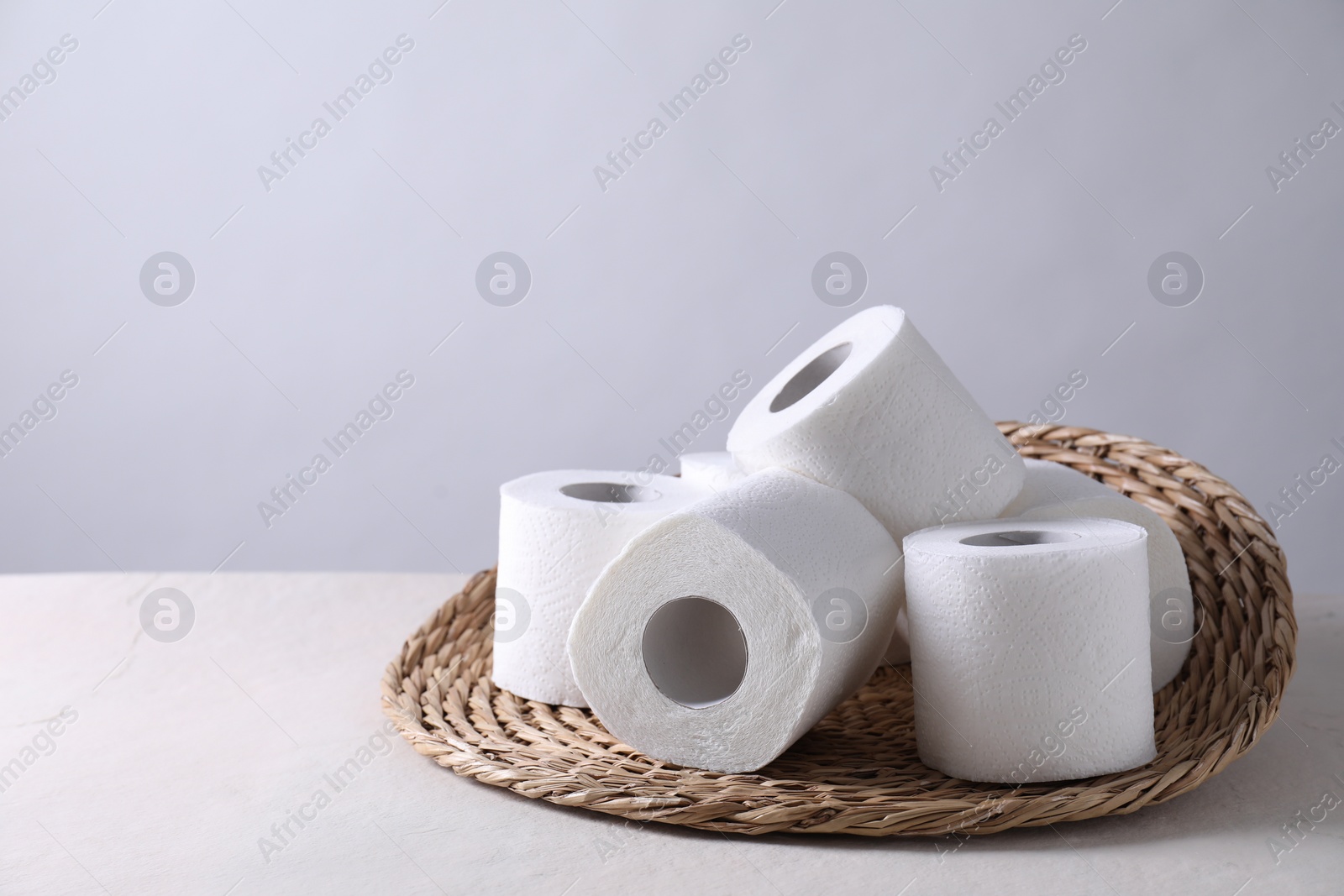 Photo of Toilet paper rolls on white table, space for text