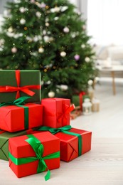 Beautifully wrapped Christmas gifts on wooden table indoors