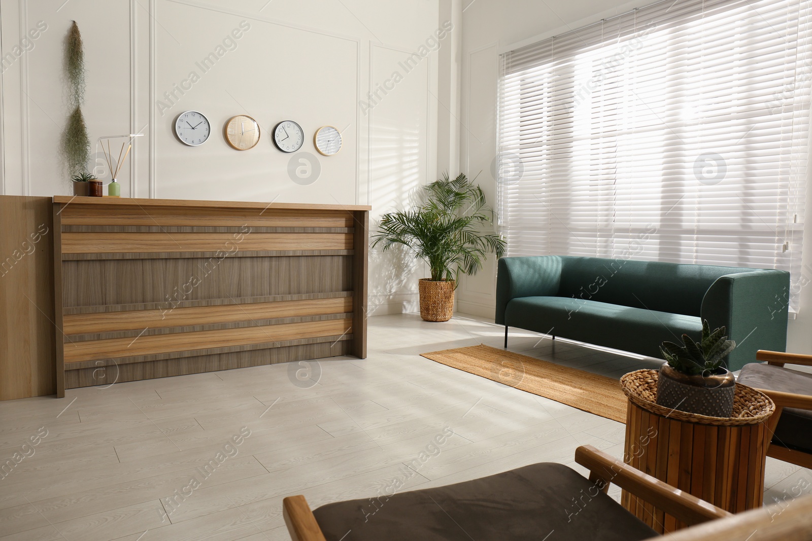 Photo of Hotel lobby interior with wooden reception desk. Stylish workplace