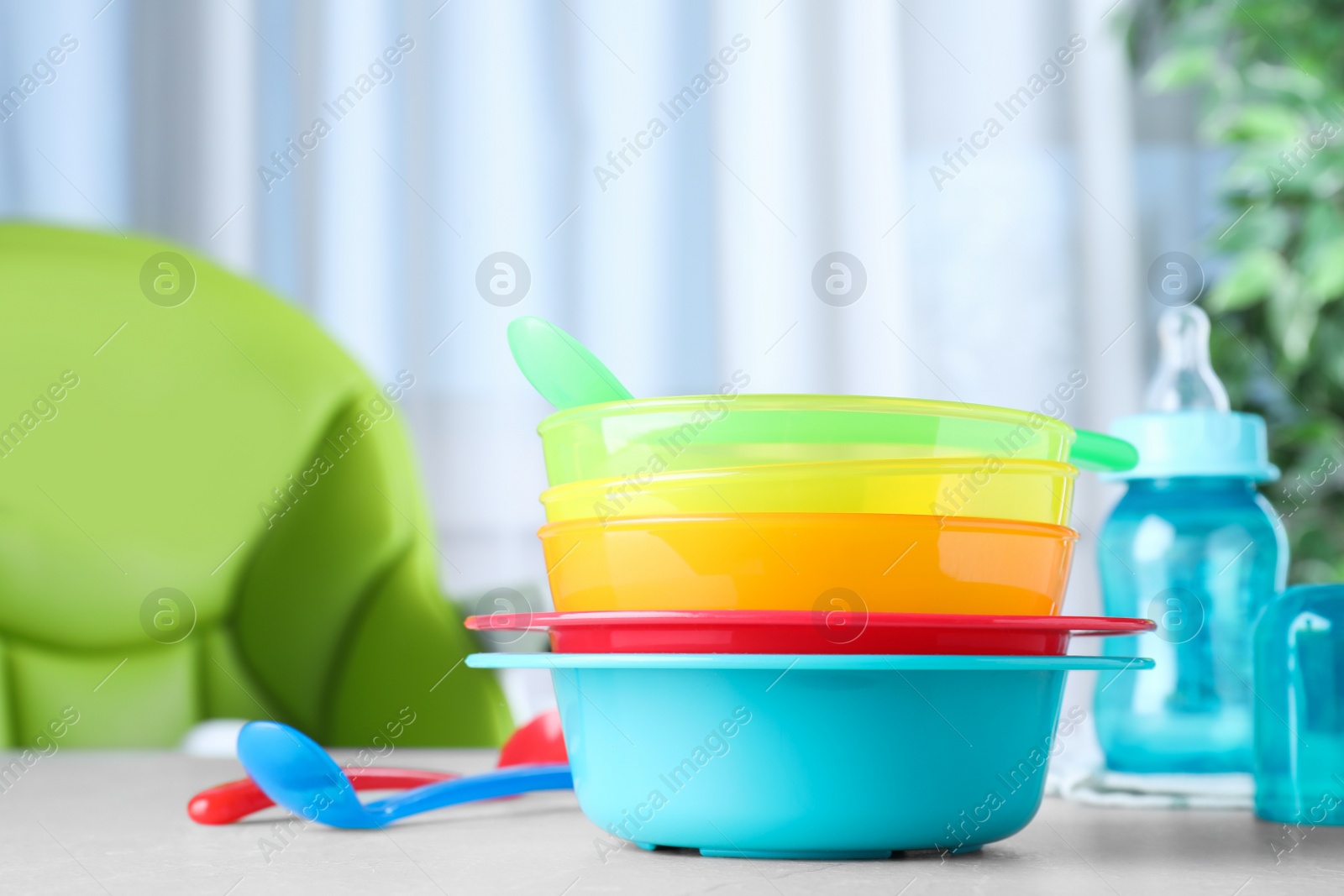 Photo of Bright child's dishware on grey table indoors