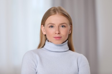 Portrait of beautiful young woman at home