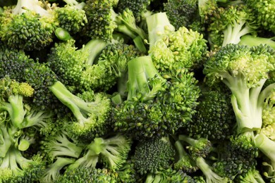 Photo of Fresh raw broccoli as background, top view