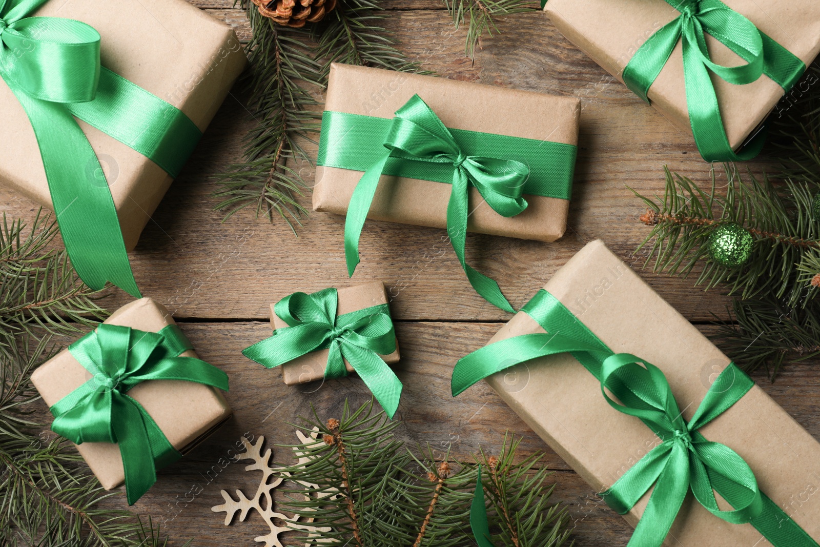 Photo of Flat lay composition with gift boxes and Christmas decorations on wooden table