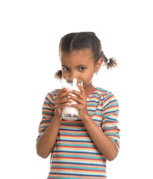 Adorable African-American girl with glass of milk on white background