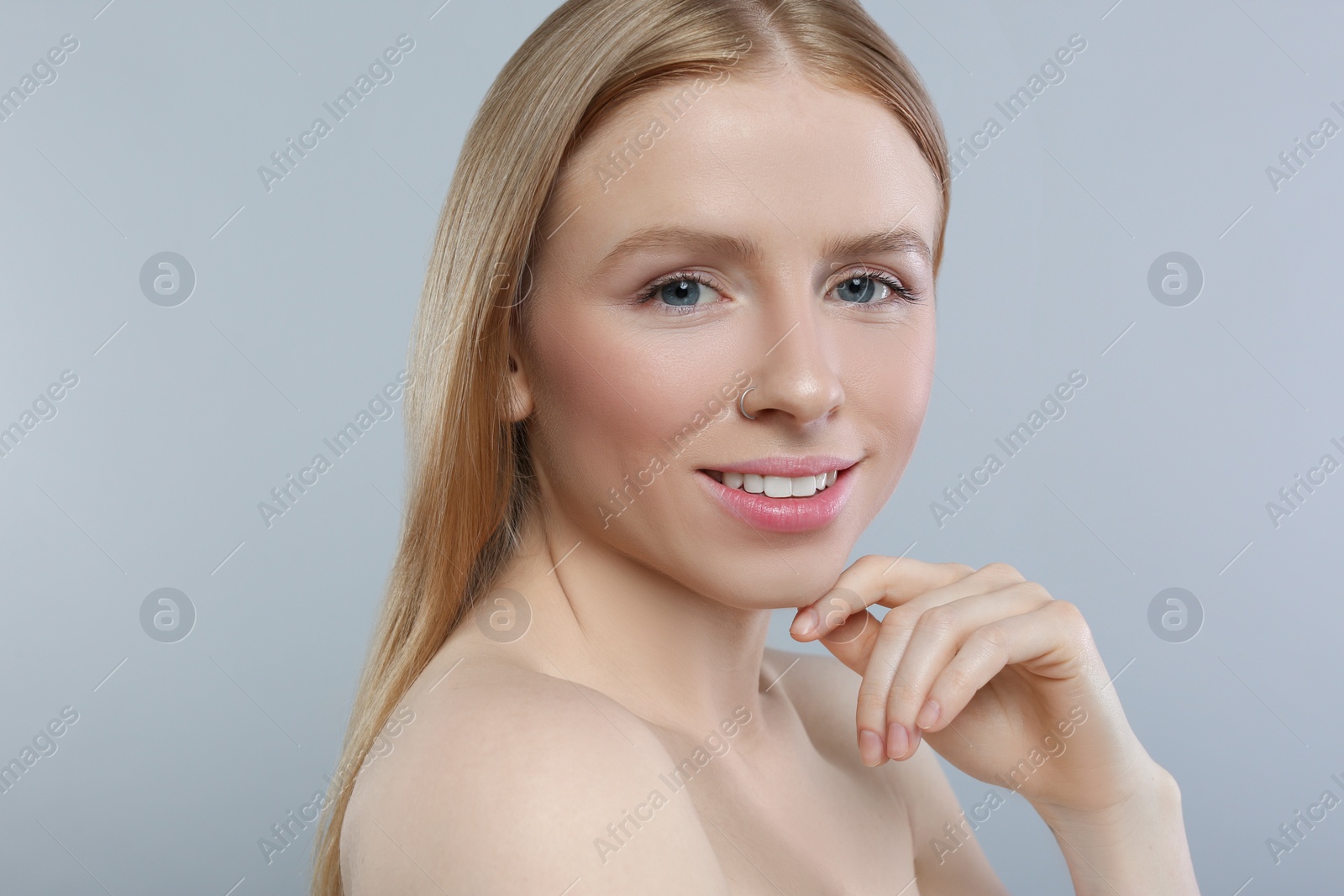 Photo of Portrait of beautiful young woman on grey background