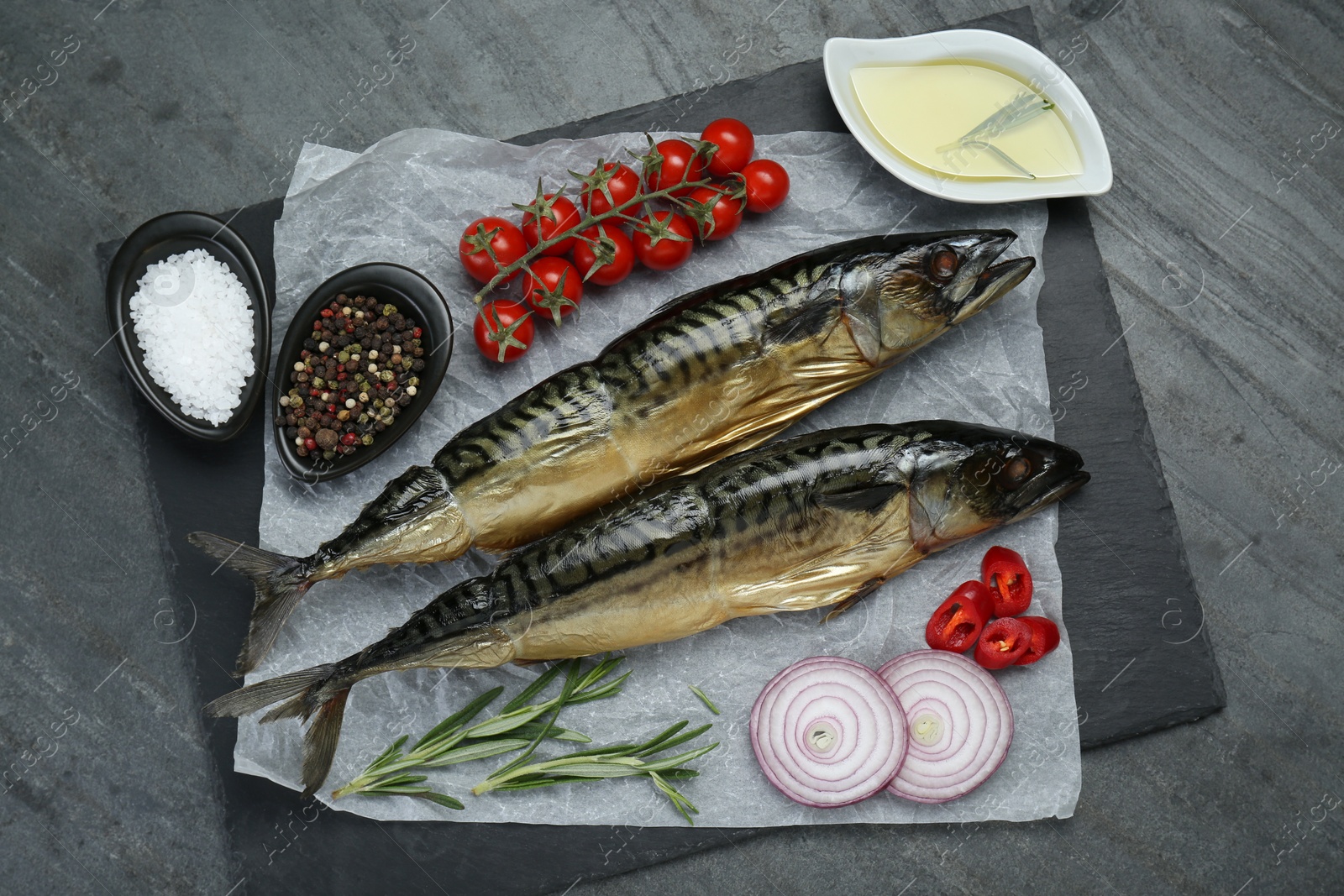 Photo of Delicious smoked mackerels and products on gray table, top view