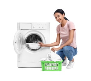 Photo of Beautiful woman taking laundry out of washing machine on white background