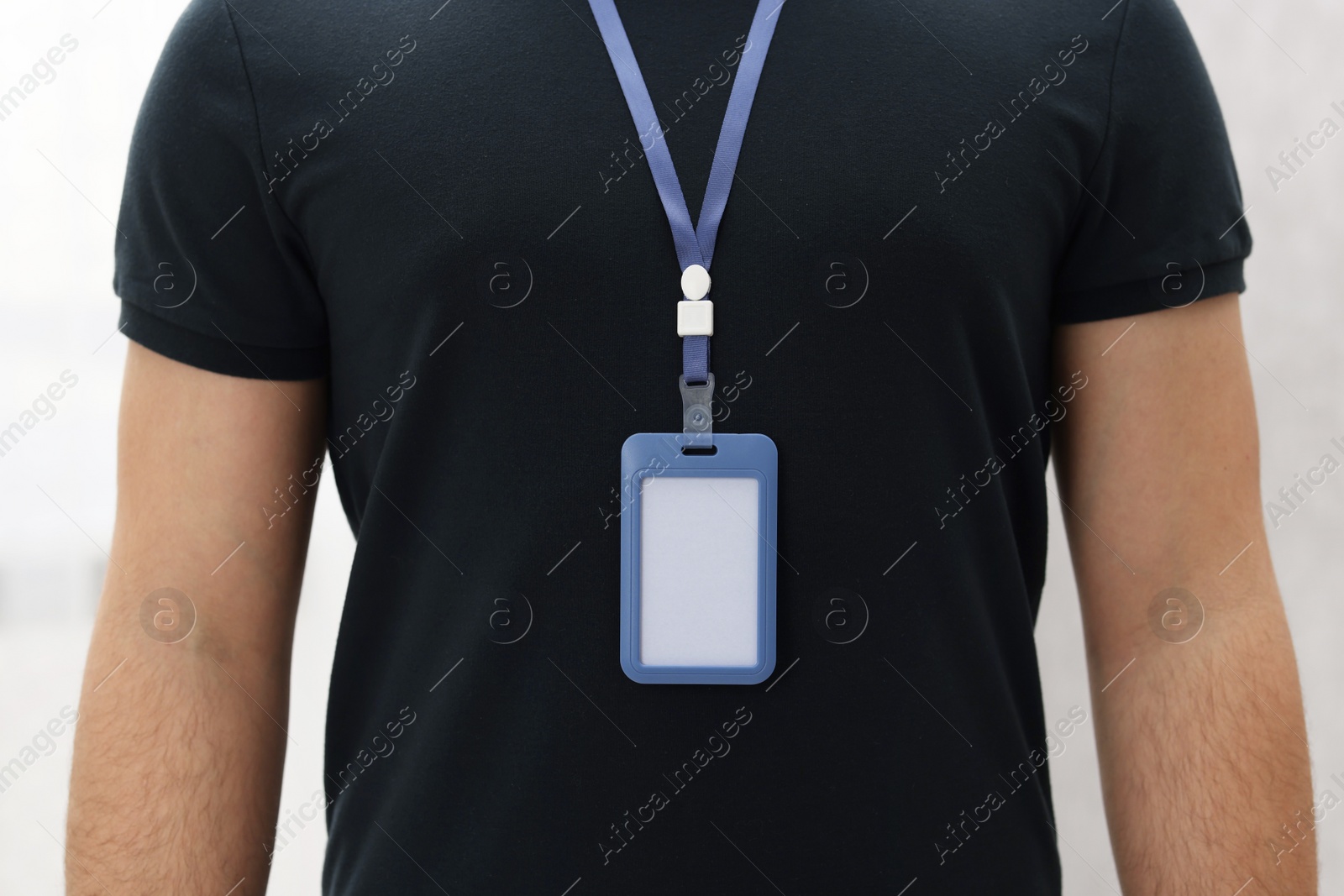 Photo of Man with blank badge indoors, closeup view