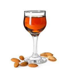 Photo of Liqueur glass with tasty amaretto and almonds isolated on white