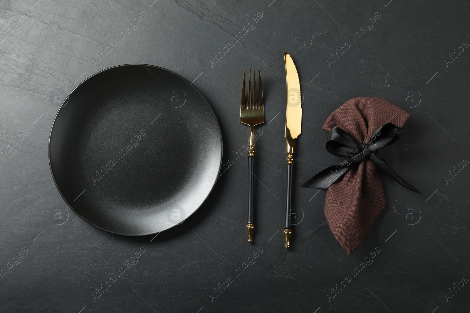 Photo of Stylish setting with elegant cutlery on grey textured table, flat lay