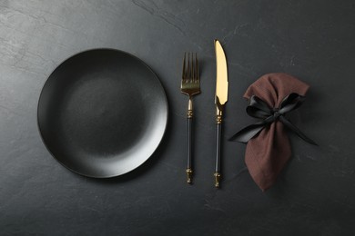 Stylish setting with elegant cutlery on grey textured table, flat lay