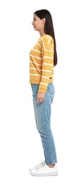 Young woman in jeans and sweater on white background