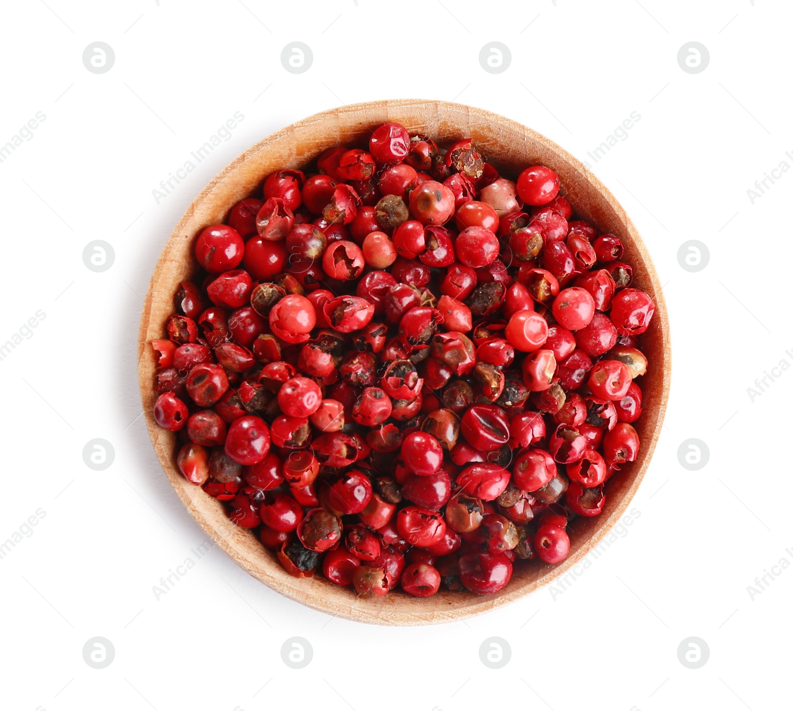 Photo of Bowl of red peppercorns isolated on white, top view