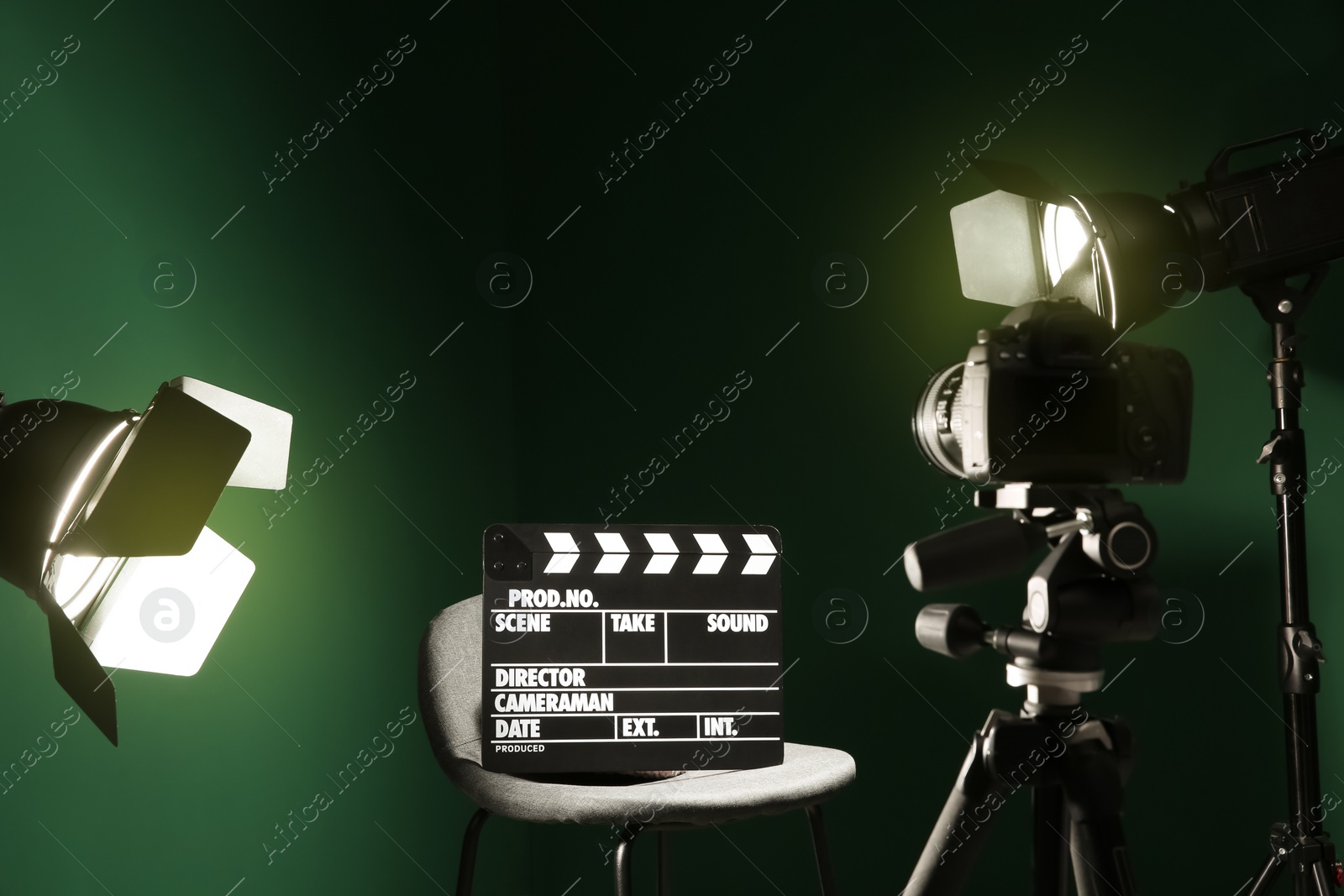 Photo of Chair with clapperboard under spotlight in studio