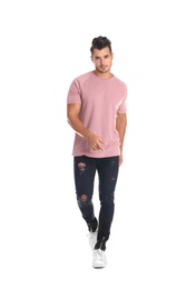 Young man in stylish jeans on white background