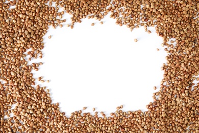 Photo of Frame made of uncooked buckwheat on white background, top view