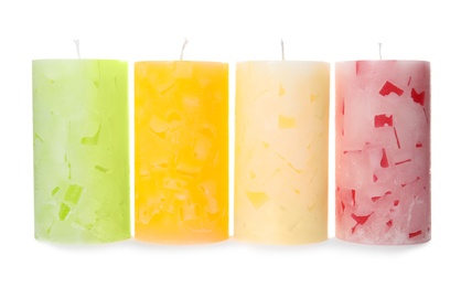 Photo of Four color wax candles on white background